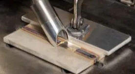 A machine cutting wood with a metal blade.