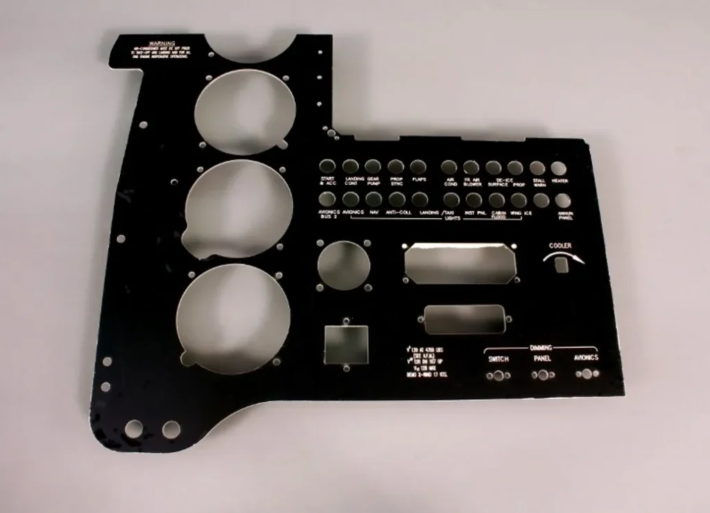 A black metal plate with various buttons and knobs.