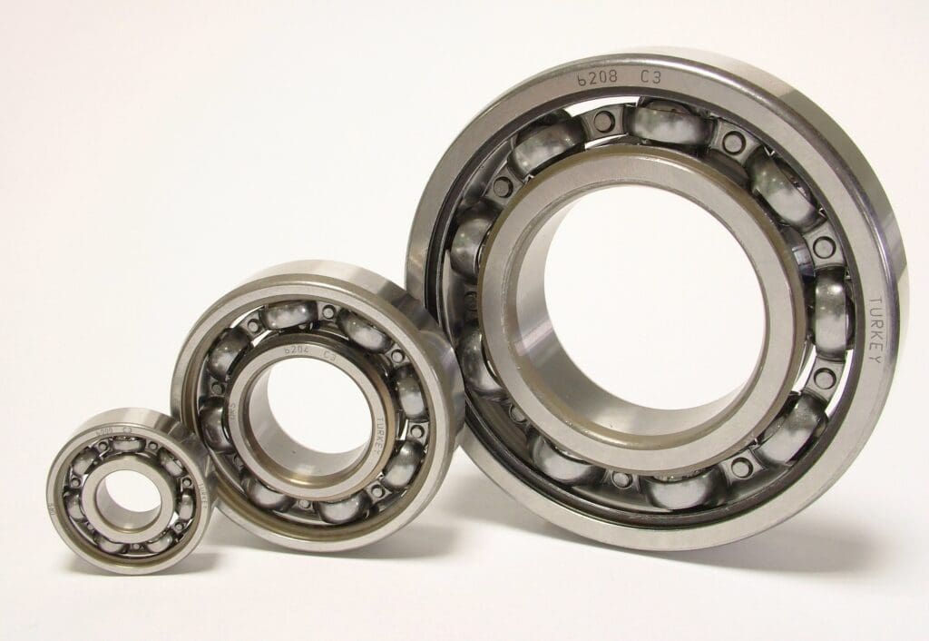 Three different sized bearings are shown on a white background.