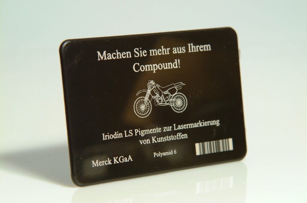 A metal card with a motorcycle on it.