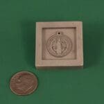 A small square wooden box with a coin next to it